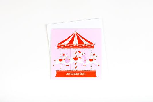 Carte de souhait illustration carrousel de Noël rose et rouge bonbon avec trois rennes écrit Joyeuses Fêtes.